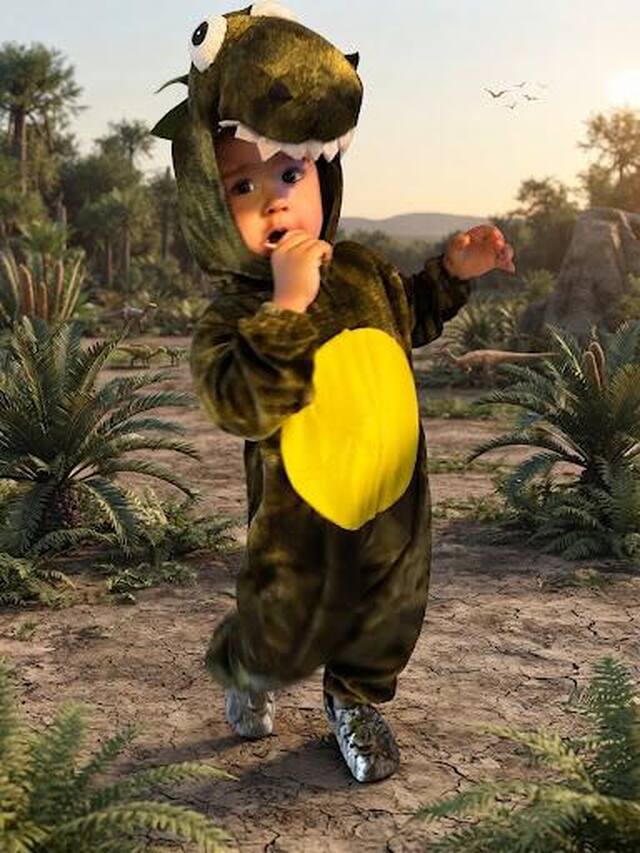 Little Juanito dressed as a T-Rex roaming through a prehistoric landscape, snacking away while getting ready for Halloween.