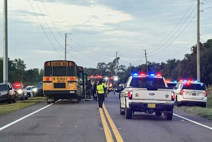 School bus flips in crash, killing two including student