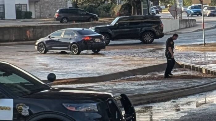 Car caught up in floodwaters stemming from North Side water main break
