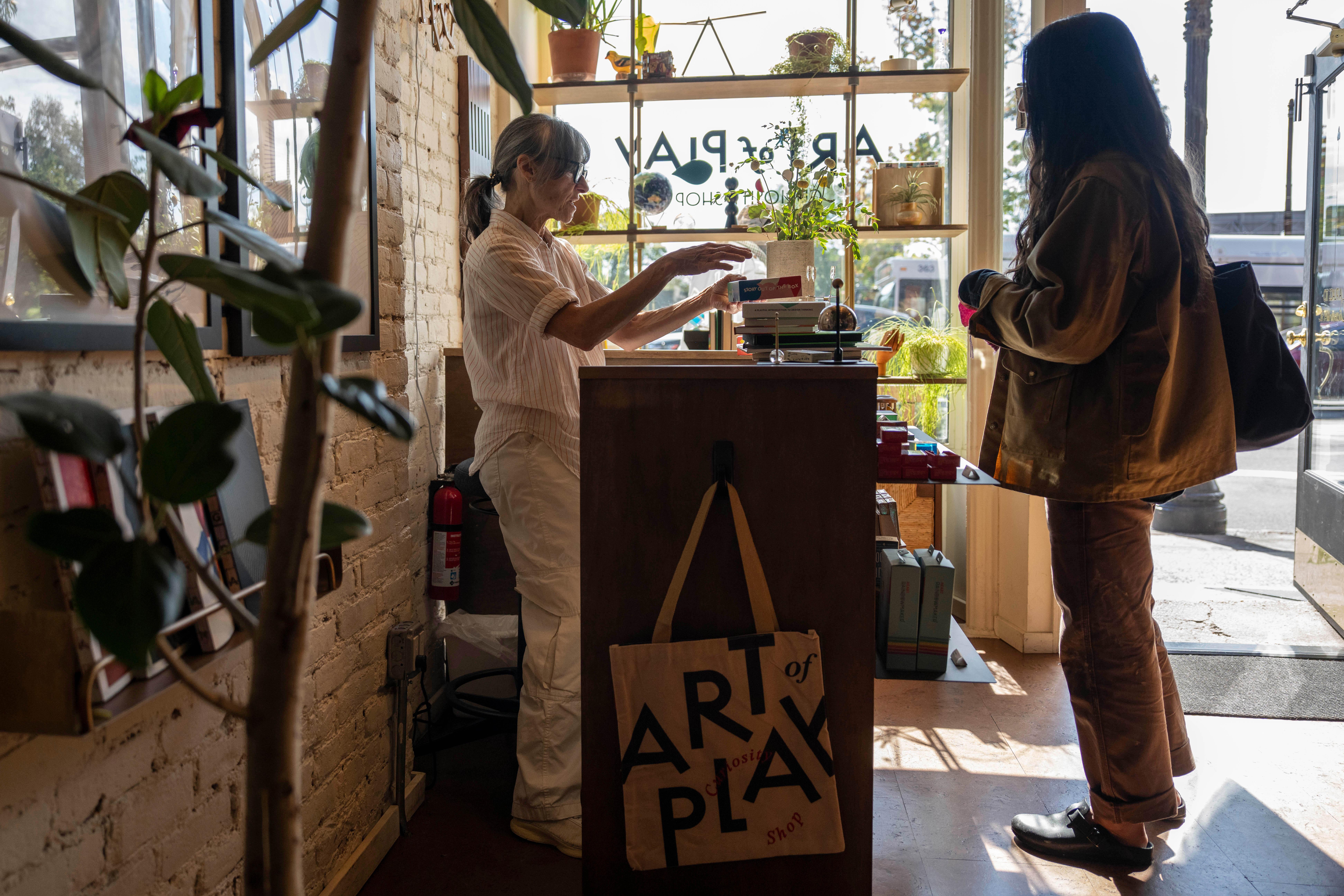 A shopper viewing an item inside Art of Play, the Brooklyn store at the center of the Kelly Clarkson and Molly bird dispute