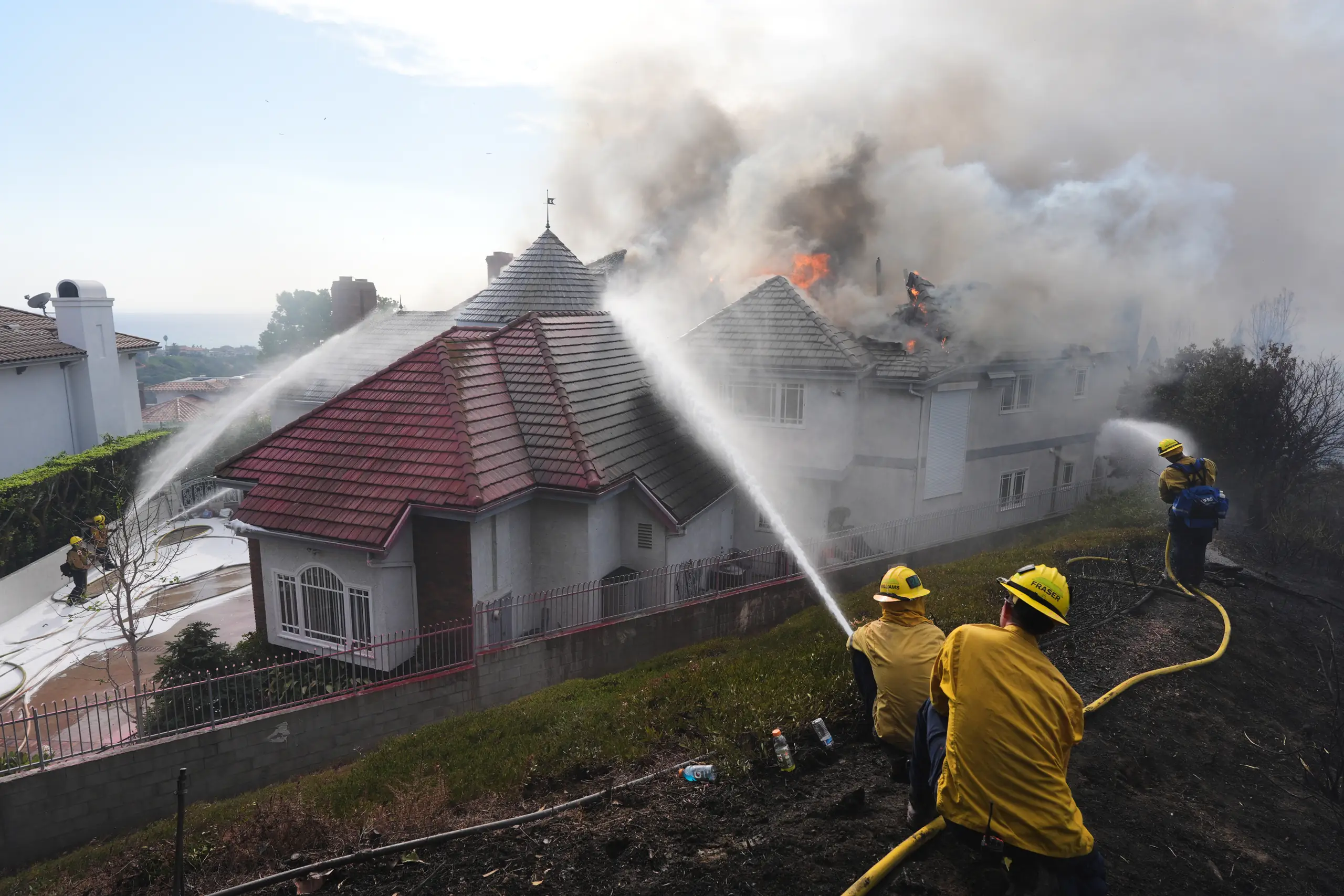 Coastal homes burn as hot winds fuel California fires