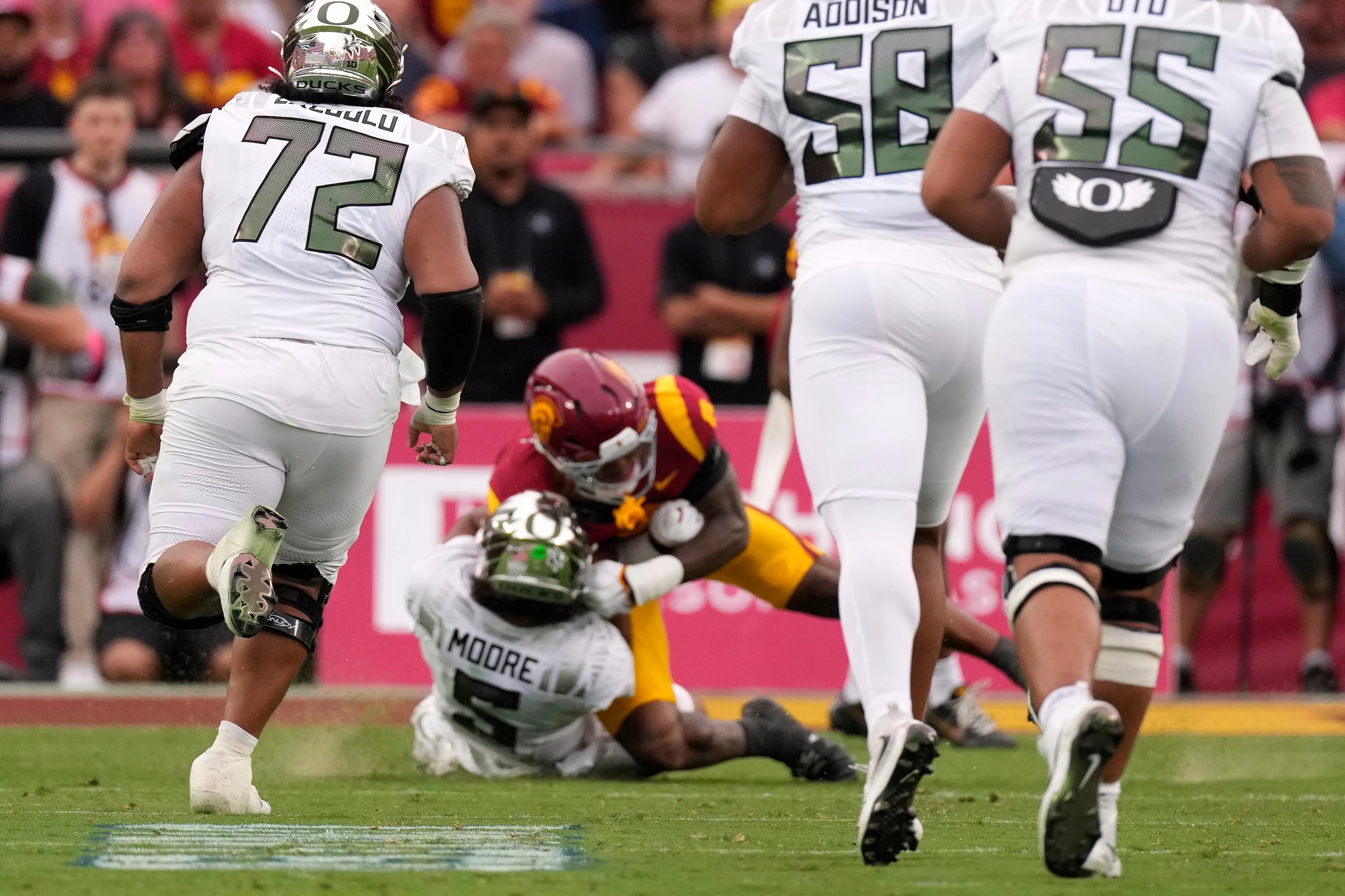 Oregon QB Dante Moore leaves field in ambulance after late hit. His Ducks rally for a stirring win